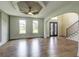 Open-concept living room with hardwood floors, decorative ceiling, and staircase at 3065 Reserve Ct Sw, Conyers, GA 30094