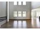 Living room with tall ceilings, fireplace, and multiple windows at 3065 Reserve Ct Sw, Conyers, GA 30094