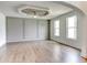 Spacious living room with large windows, hardwood floors, and unique ceiling design at 3065 Reserve Ct Sw, Conyers, GA 30094