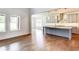Open living space with hardwood floors, a kitchen island, and natural light at 3065 Reserve Ct Sw, Conyers, GA 30094