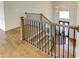 Staircase boasts hardwood treads, an iron railing, and abundant natural light at 3065 Reserve Ct Sw, Conyers, GA 30094