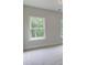 Comfortable carpeted bedroom with bright windows and neutral paint, offering serene views at 3292 Mill Forest Dr, Conyers, GA 30094