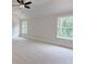 Bright bedroom with neutral walls and carpets, ceiling fan, vaulted ceilings and two windows at 3292 Mill Forest Dr, Conyers, GA 30094