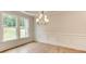 Dining area with hardwood floors, decorative molding, and a large window overlooking nature at 3292 Mill Forest Dr, Conyers, GA 30094