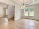 Dining area boasts hardwood floors, wainscoting, and a chandelier at 3292 Mill Forest Dr, Conyers, GA 30094