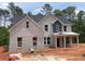 Charming two-story home with light brick, gray shingles, and covered front porch at 3292 Mill Forest Dr, Conyers, GA 30094
