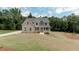 Charming two-story home with a large yard, gray shingles, and inviting front porch at 3292 Mill Forest Dr, Conyers, GA 30094