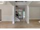 Elegant foyer with hardwood floors, staircase, and decorative columns at 3292 Mill Forest Dr, Conyers, GA 30094