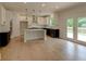 Modern kitchen with white cabinets, stainless steel appliances, and a central island with black countertops at 3292 Mill Forest Dr, Conyers, GA 30094