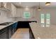 Bright kitchen featuring granite countertops, white backsplash, and stainless steel appliances at 3292 Mill Forest Dr, Conyers, GA 30094