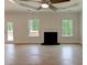 Spacious living room with hardwood floors, fireplace, and multiple windows at 3292 Mill Forest Dr, Conyers, GA 30094