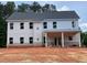 Two-story home with white siding, multiple windows, and a covered back porch at 3292 Mill Forest Dr, Conyers, GA 30094