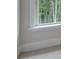 Bright window framing a peaceful wooded view, complemented by white trim and neutral carpet at 3292 Mill Forest Dr, Conyers, GA 30094
