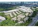 Aerial shot of beautiful townhomes surrounded by lush greenery near a bustling city at 661 Lockton Pl, Sandy Springs, GA 30342