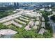 Aerial view of townhomes in a lush, green neighborhood near a highway at 661 Lockton Pl, Sandy Springs, GA 30342