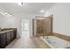 Bright bathroom with double vanity, soaking tub, and a glass-enclosed shower at 661 Lockton Pl, Sandy Springs, GA 30342