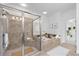 Bright bathroom with a glass shower, tub with decor, and plants enhancing a serene atmosphere at 661 Lockton Pl, Sandy Springs, GA 30342