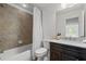 Well lit, cozy bathroom with a shower-tub combination and dark wood cabinets at 661 Lockton Pl, Sandy Springs, GA 30342