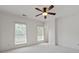 A bright bedroom with a ceiling fan and two windows that provide natural light at 661 Lockton Pl, Sandy Springs, GA 30342