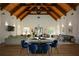 Interior view of a clubhouse with a vaulted ceiling, hardwood floors, and ample seating at 661 Lockton Pl, Sandy Springs, GA 30342