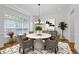 Bright dining room features a modern light fixture and elegant white marble table with seating for six at 661 Lockton Pl, Sandy Springs, GA 30342