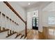 Elegant foyer featuring hardwood floors, staircase with wooden banister and entrance with sidelights at 661 Lockton Pl, Sandy Springs, GA 30342