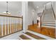 Bright foyer with hardwood floors, stairs, and chandelier adds elegance to this home at 661 Lockton Pl, Sandy Springs, GA 30342