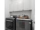 Modern laundry room featuring new washer and dryer units, and overhead storage at 661 Lockton Pl, Sandy Springs, GA 30342