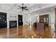 Open concept living room with a fireplace, kitchen island, and hardwood floors throughout at 661 Lockton Pl, Sandy Springs, GA 30342