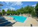 Community pool surrounded by lounge chairs and green trees on a bright day at 661 Lockton Pl, Sandy Springs, GA 30342