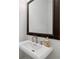 Close up on the pedestal sink with ornate mirror in the powder room at 661 Lockton Pl, Sandy Springs, GA 30342