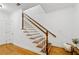 Elegant staircase with wooden handrail and white balusters leading to the upper level, adding charm to the home at 661 Lockton Pl, Sandy Springs, GA 30342