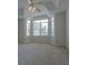 Bright bedroom featuring neutral carpet, a bay window, and a ceiling fan for comfortable living at 1015 Mcgill Park Ne Ave, Atlanta, GA 30312
