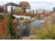 Breathtaking aerial view of a serene pond featuring a fountain, surrounded by vibrant autumn foliage at 1015 Mcgill Park Ne Ave, Atlanta, GA 30312