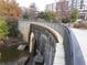 Picturesque stone waterfall and pond surrounded by walking path and cityscape views at 1015 Mcgill Park Ne Ave, Atlanta, GA 30312
