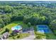 Aerial view of community pool and tennis courts surrounded by lush trees at 4174 Chatham Crest Ln, Buford, GA 30518