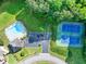 Aerial view of community amenities including a pool, tennis courts, and parking area at 4174 Chatham Crest Ln, Buford, GA 30518