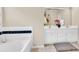 Bathroom featuring dual sinks, a bathtub with tiled accents, and ample counter space at 4174 Chatham Crest Ln, Buford, GA 30518