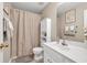 Bathroom features a white vanity, toilet, cabinet and a neutral shower curtain for a clean aesthetic at 4174 Chatham Crest Ln, Buford, GA 30518