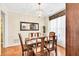 Formal dining room with hardwood floors, elegant lighting, and a large mirror at 4174 Chatham Crest Ln, Buford, GA 30518