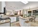 Bright kitchen features granite countertops, stainless steel appliances, an island, and a breakfast nook with backyard views at 4174 Chatham Crest Ln, Buford, GA 30518