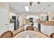 Eat-in kitchen with granite counters, stainless steel appliances, kitchen island and view to the rest of the home at 4174 Chatham Crest Ln, Buford, GA 30518