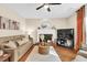 Cozy living room with a fireplace, modern decor, and hardwood floors at 4174 Chatham Crest Ln, Buford, GA 30518