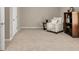 Cozy living room with an accent chair, side table, bookshelf, and neutral colored walls and carpet at 4174 Chatham Crest Ln, Buford, GA 30518
