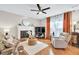 Cozy living room with a fireplace, hardwood floors, and neutral decor at 4174 Chatham Crest Ln, Buford, GA 30518