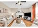 Comfortable living room featuring a fireplace, hardwood floors, and large TV at 4174 Chatham Crest Ln, Buford, GA 30518