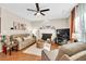 Living room boasts hardwood floors, fireplace, and plush seating at 4174 Chatham Crest Ln, Buford, GA 30518