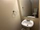 This half bathroom features a pedestal sink, mirror, and toilet at 6536 Rebecca Lou Ln, Lithonia, GA 30058
