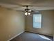 Bedroom features carpeted floors, neutral walls, a ceiling fan, and a window at 6536 Rebecca Lou Ln, Lithonia, GA 30058