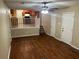 Living room with wood-look flooring, ceiling fan, and a staircase leading to an open-concept kitchen at 6536 Rebecca Lou Ln, Lithonia, GA 30058